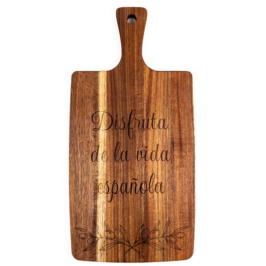 Wooden cutting board with engraved Spanish text on a white background. Acacia wood laser engraved charcuterie board and serving board handmade in Spain 