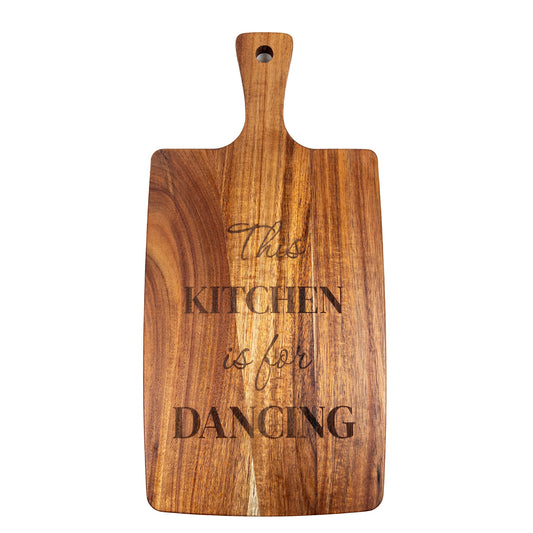 Wooden cutting board with 'This kitchen is for dancing' text on a white background. Acacia wood laser engraved charcuterie board and serving board handmade in Spain 