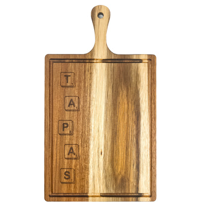 Wooden cutting board with 'TAPAS' engraved on a white background
Acacia wood laser engraved serving board handmade in Spain 
