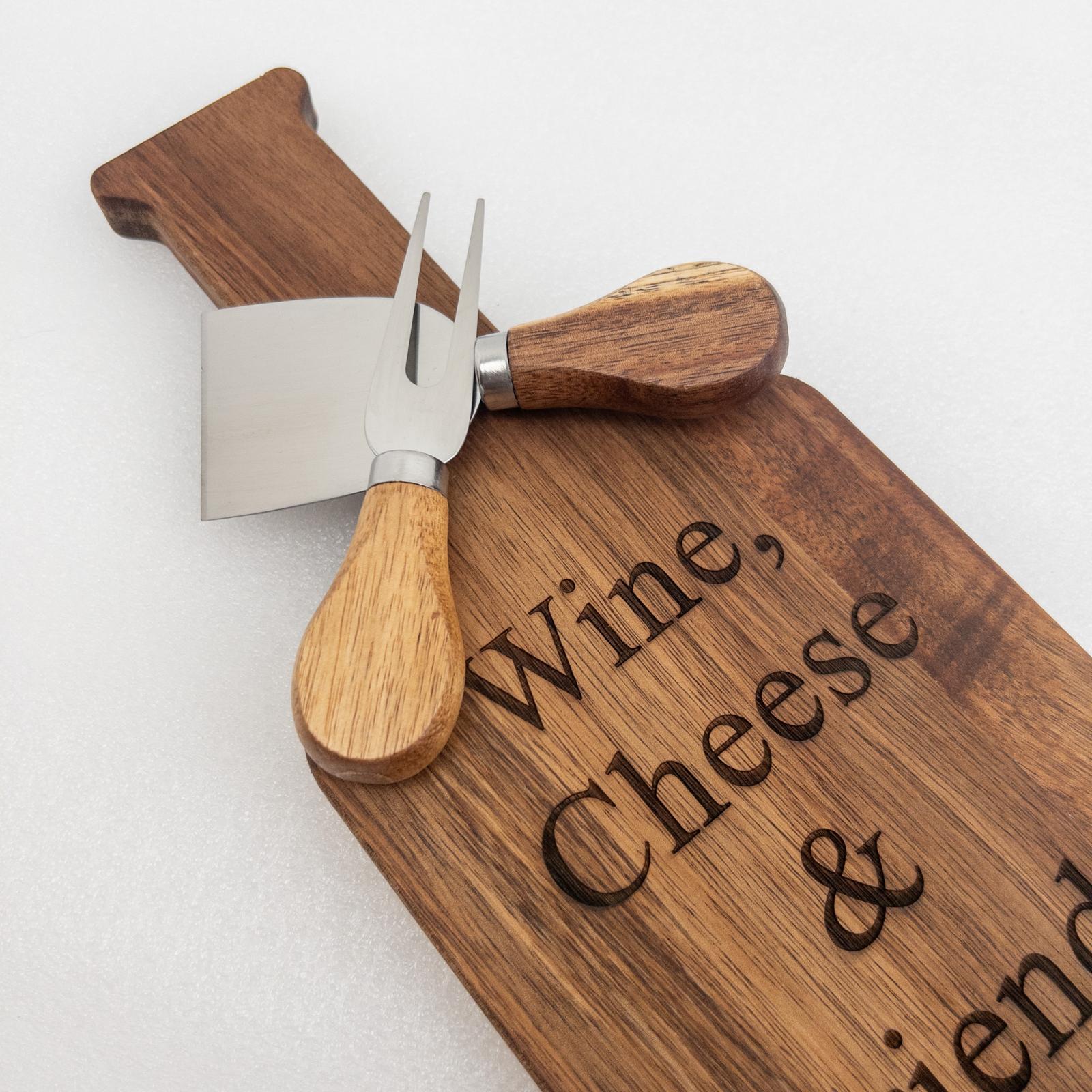 Wooden cutting board with engraved text and an acacia cheese knife set LUNA 