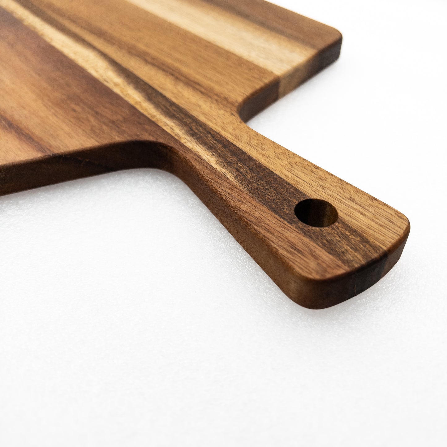Wooden cutting board with a handle on a white background