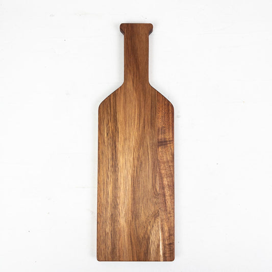 Bottle-shaped acacia wooden serving board on a white background
