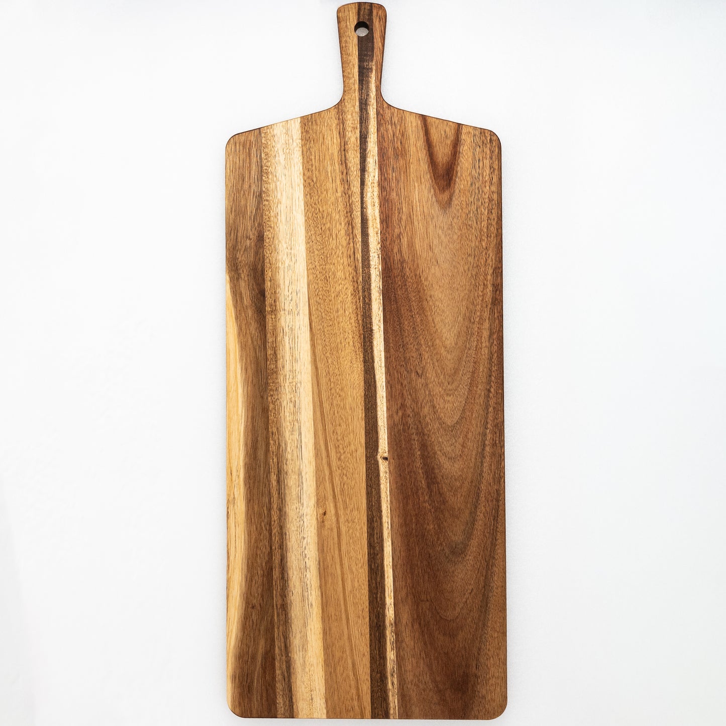 Large wooden tapas board with a handle on a white background